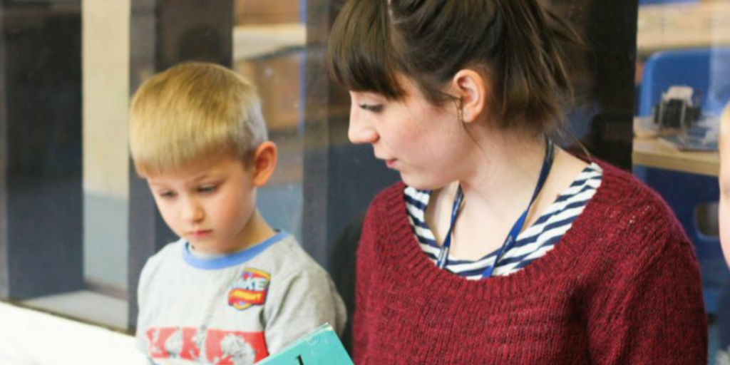 Early years nursery practitioner with child