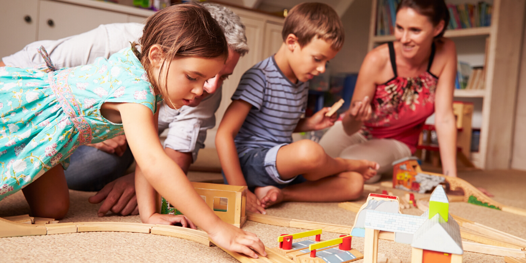 family playing on the floor with their children