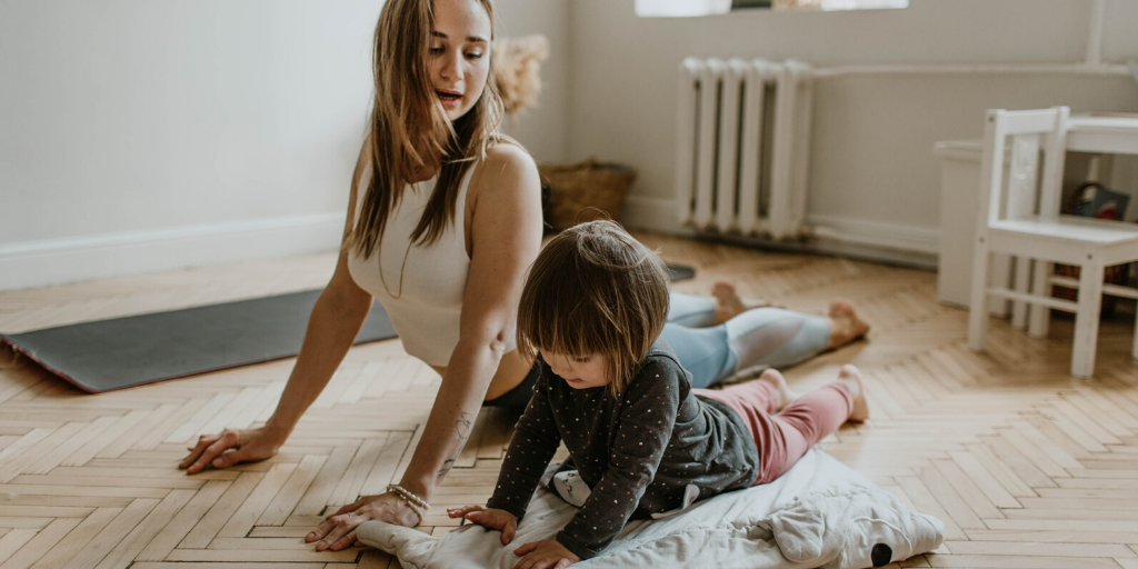 mum and child doing yoga in their livingroom