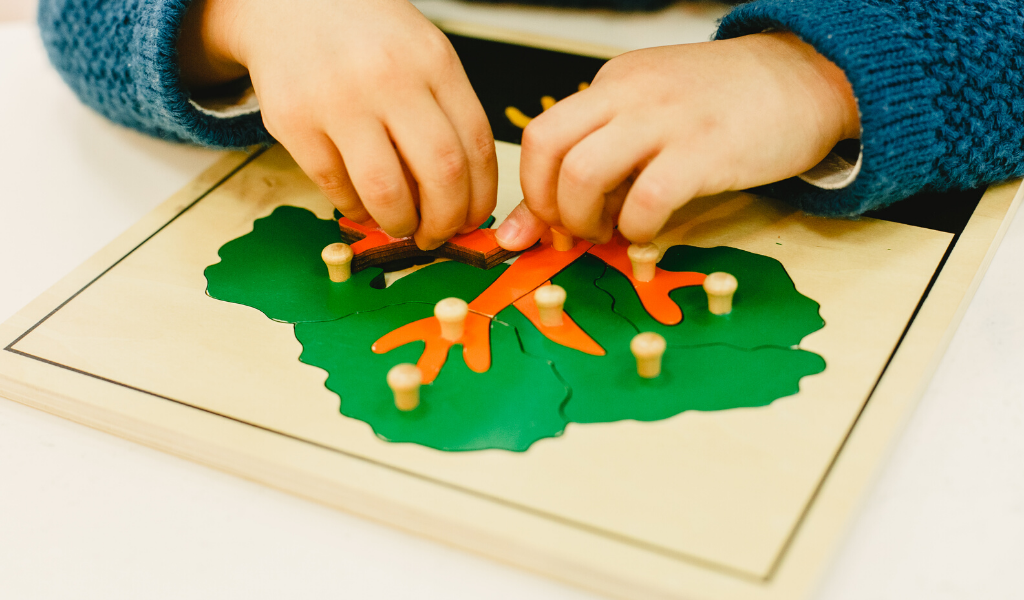 a child playing with wooden toy