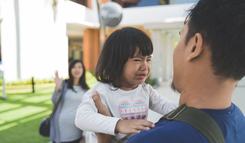 child crying as she's separated from dad