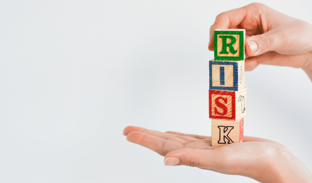 hands holding risk toy cubes