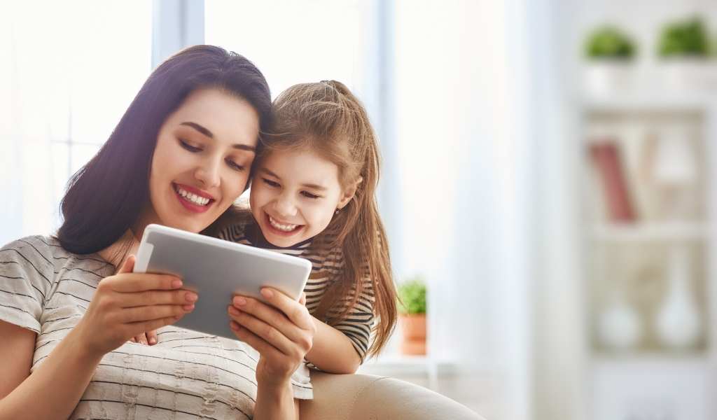 mum showing child a video on an ipad