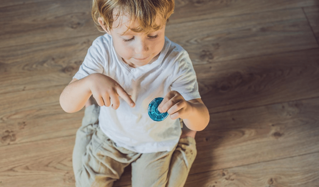 autistic child spinning a toy