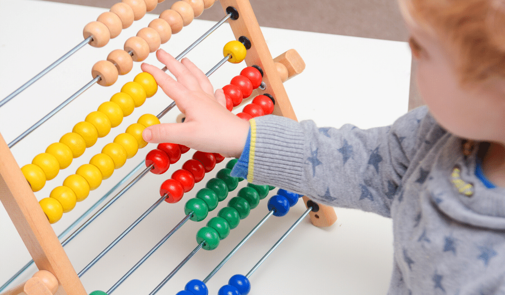 baby playing with an abacus