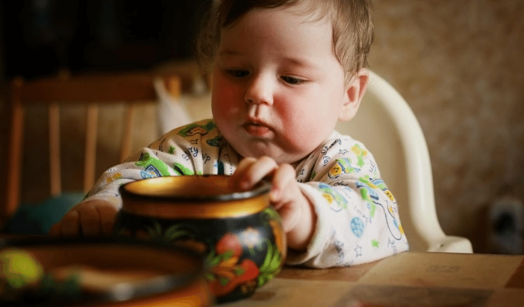 baby playing with cup