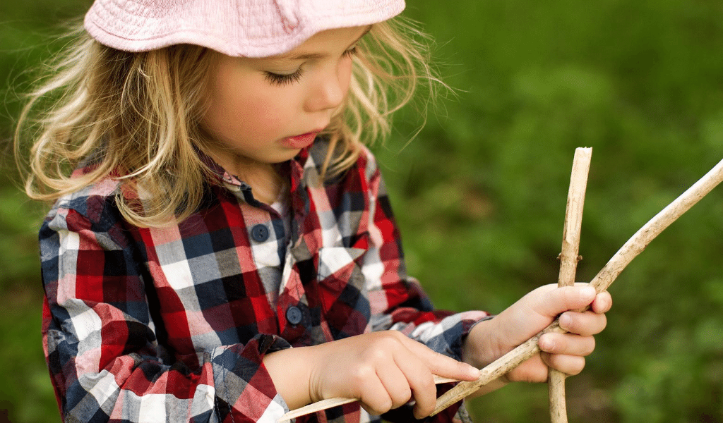 girl playing with sticks