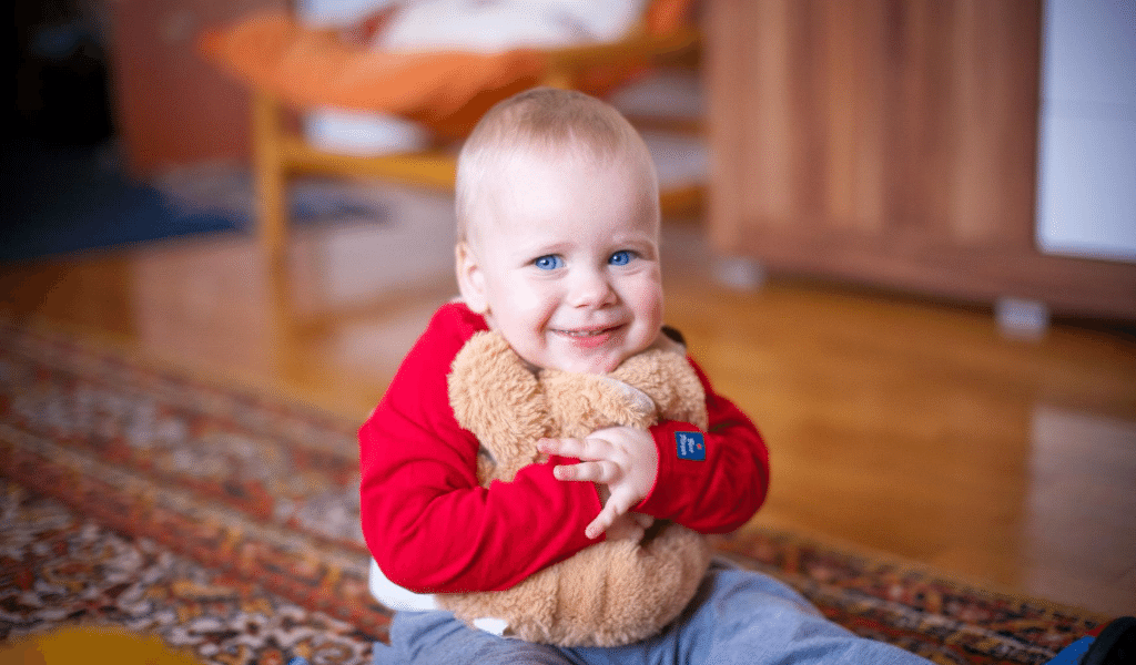 baby hugging a teddy bear