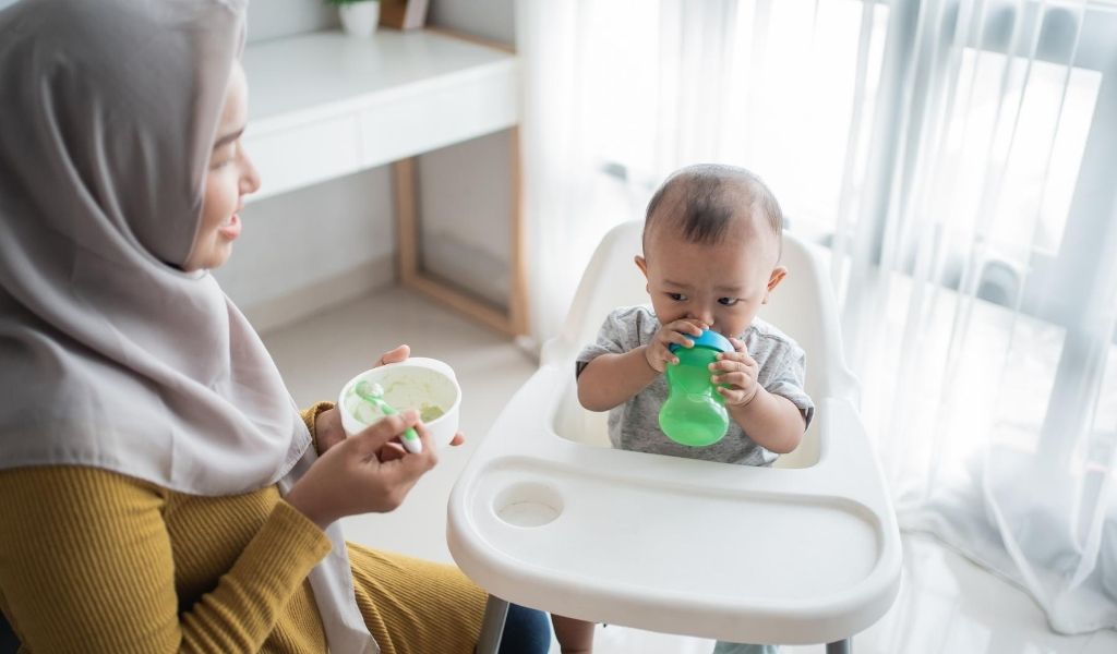 Asian baby drinking from bottle