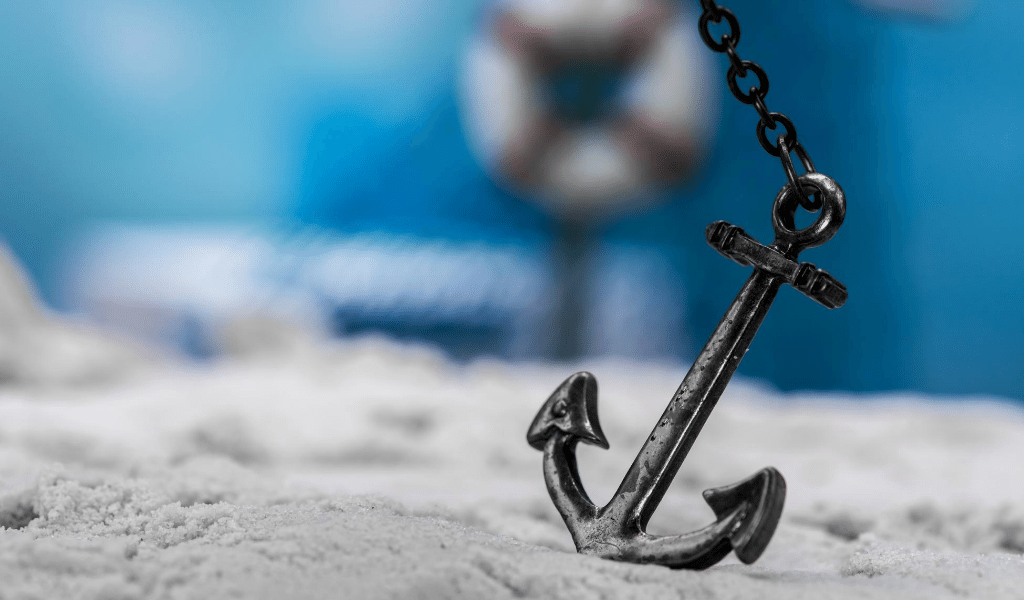 a small anchor on the sand