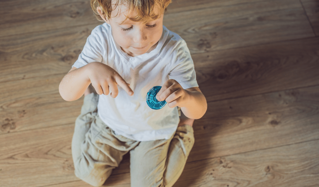 autistic boy playing with fidget