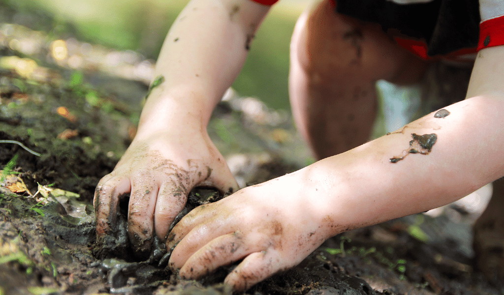 child playing with mud