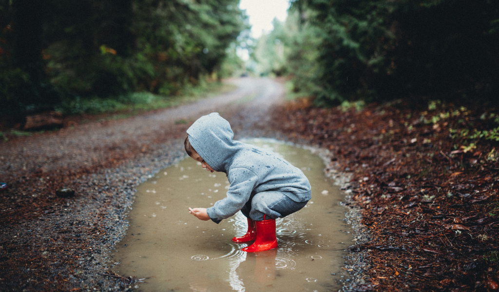 child playing in a pool of water