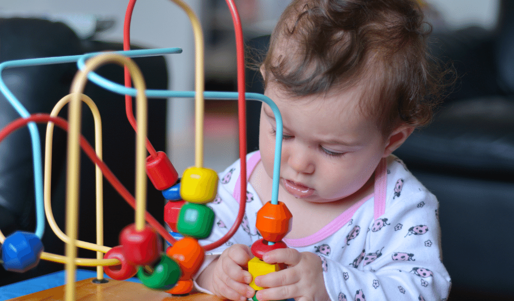 baby girl playing with toy