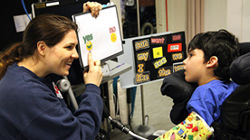 Practitioner using symbols to support non-verbal child