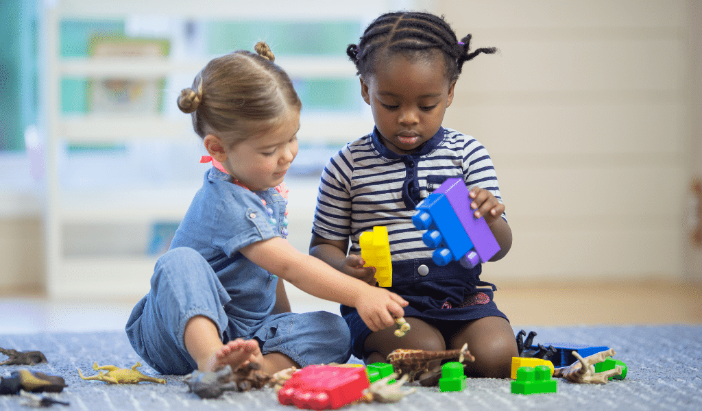 toddlers playing with toys on floor