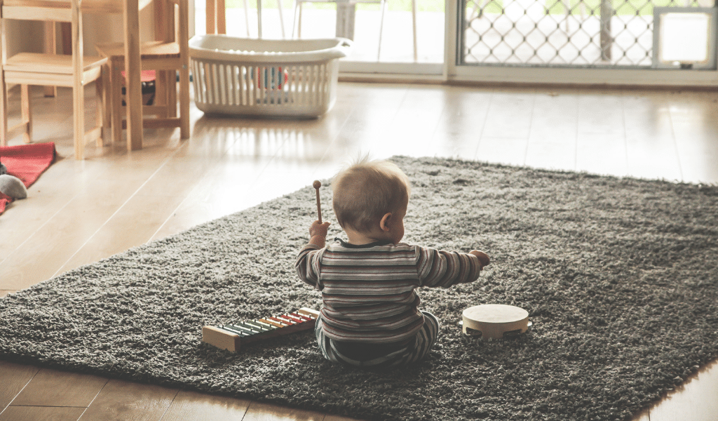 baby playing with instruments on floor