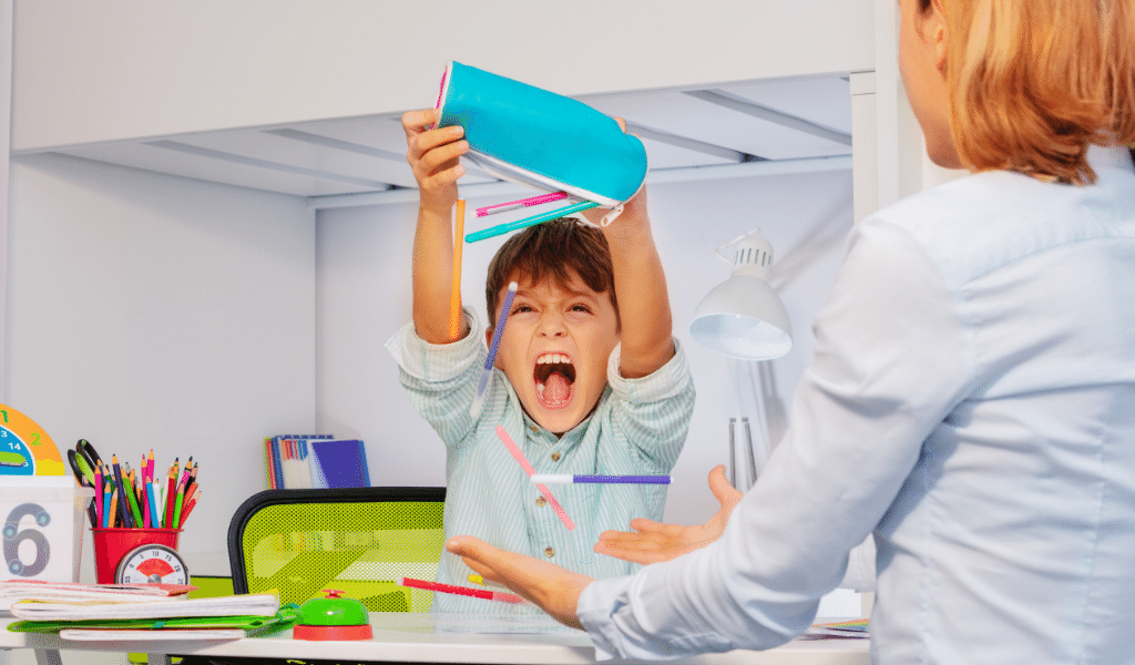 child throwing pens out of pencil case in a tantrum