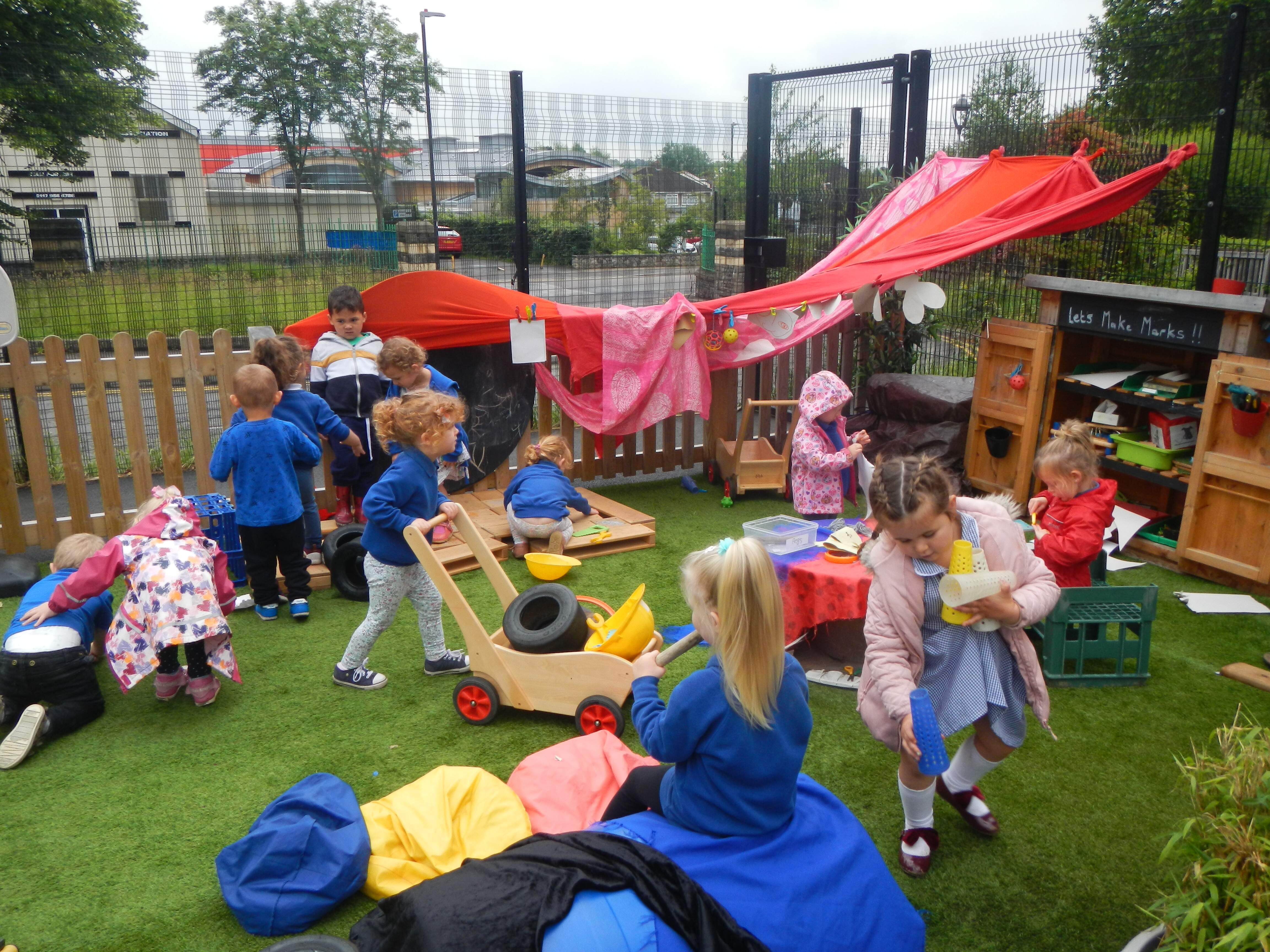 An children playing outdoors in nursery 