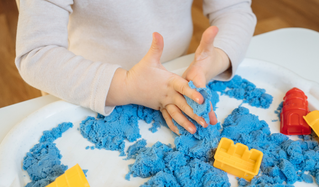 child playing with blue dough