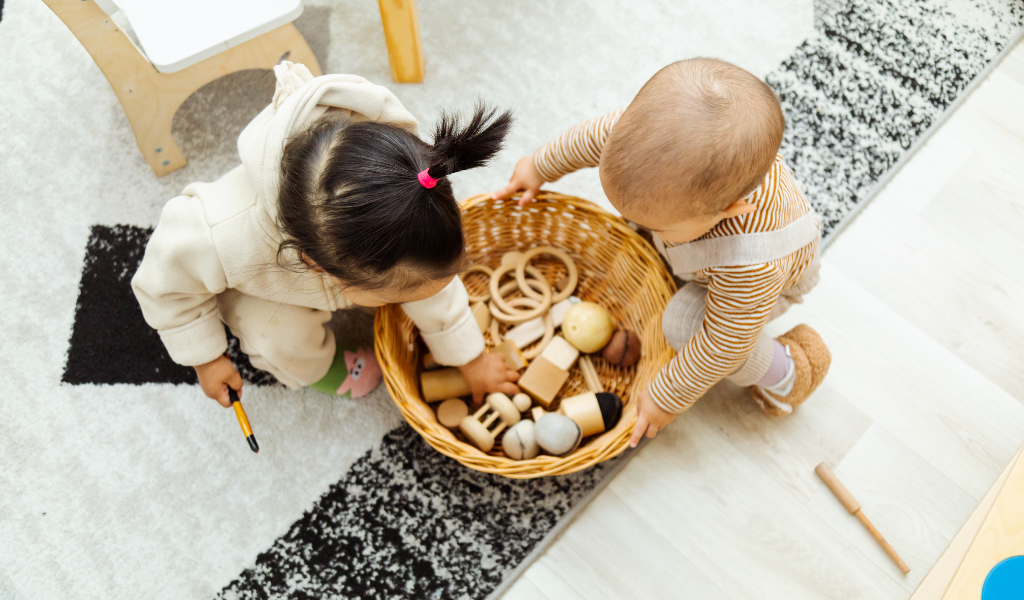 young children playing with items in a basket