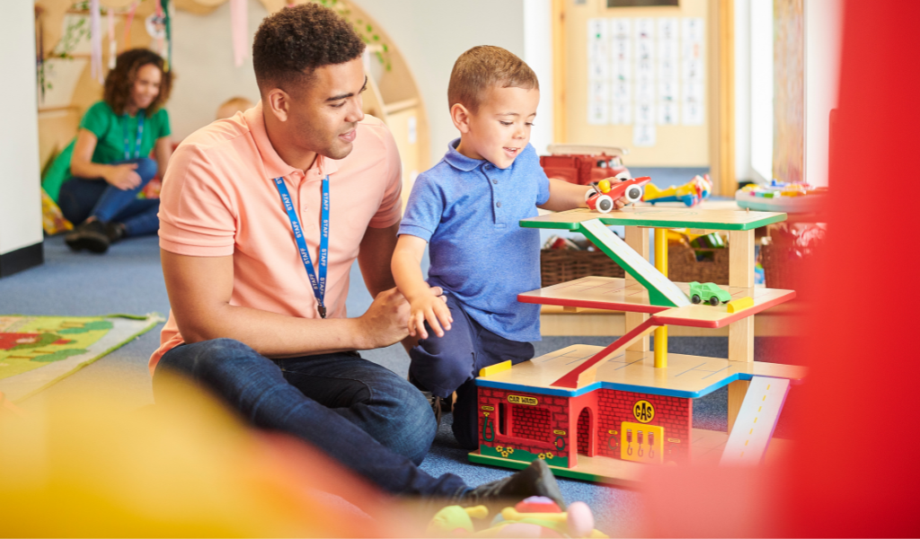 man childminder supporting a child at nursery