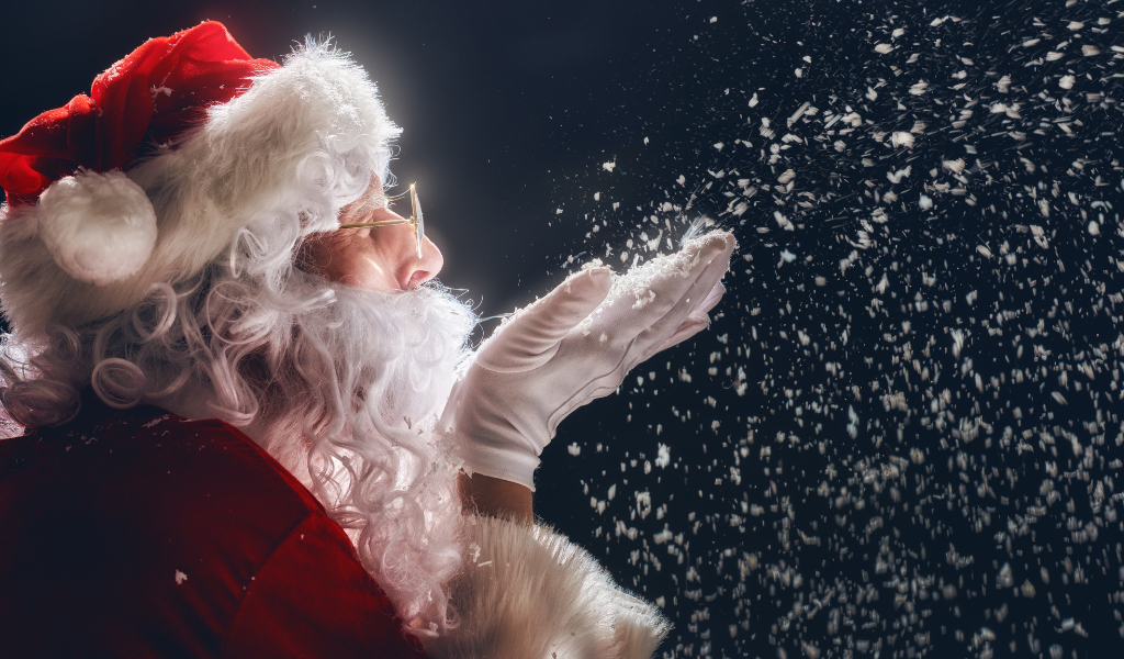 Santa blowing snow off his hand