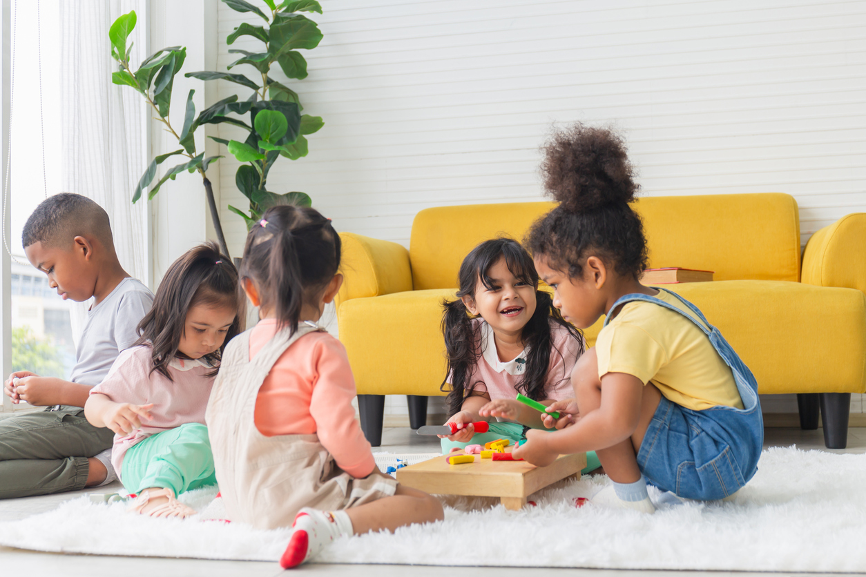 Cute little children playing toys in living room, Diverse children enjoying playing with toys