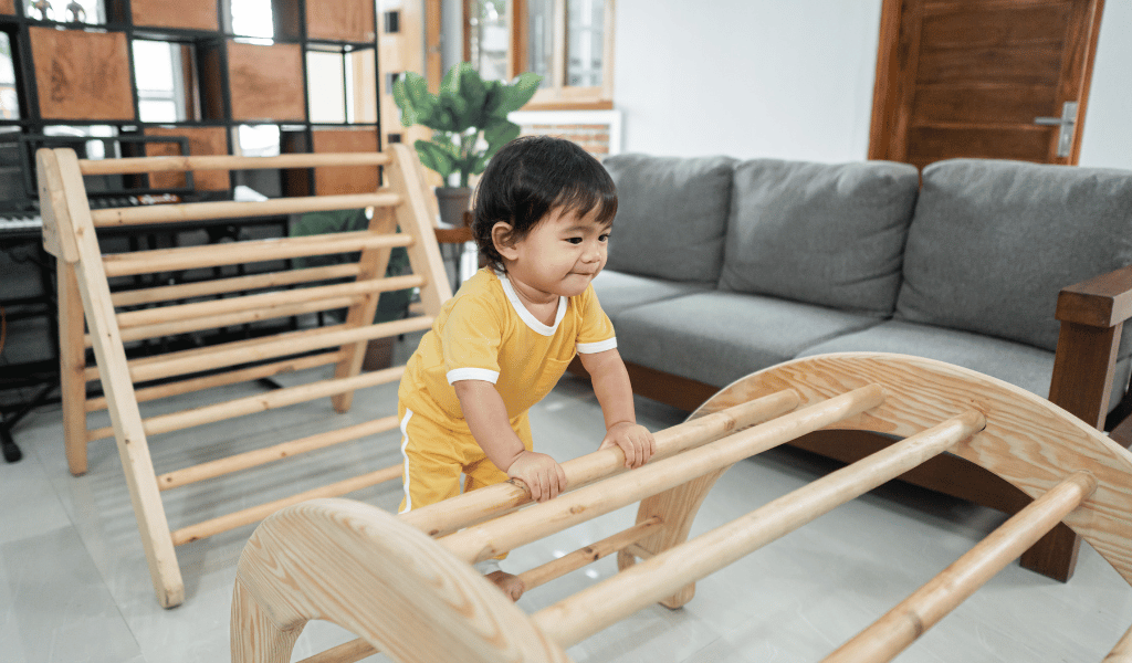 asian child playing with wooden structure