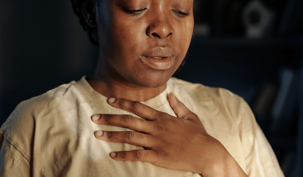 woman feeling her stress on her chest