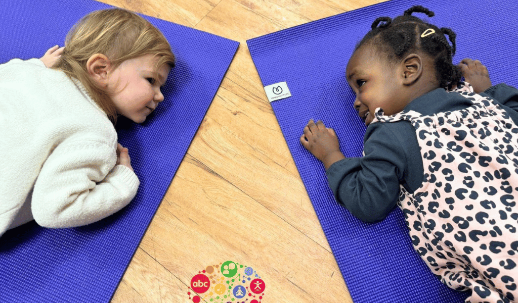 children lying on a yoga matt