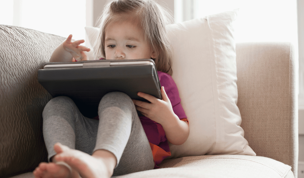 toddler playing with tablet